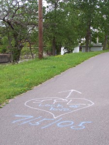 Lock of Love Painted tag on the Canal Path near the west guard lock that says "JPL Lock of Love" in a heart with an arrow pointing to the guard lock and the date 7/5/05.
