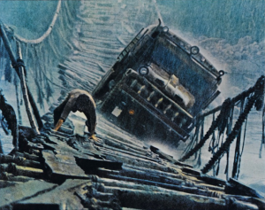 Painting of a huge truck attempting to cross a rickety wooden bridge as a man stands in front, apparently repairing the boards.